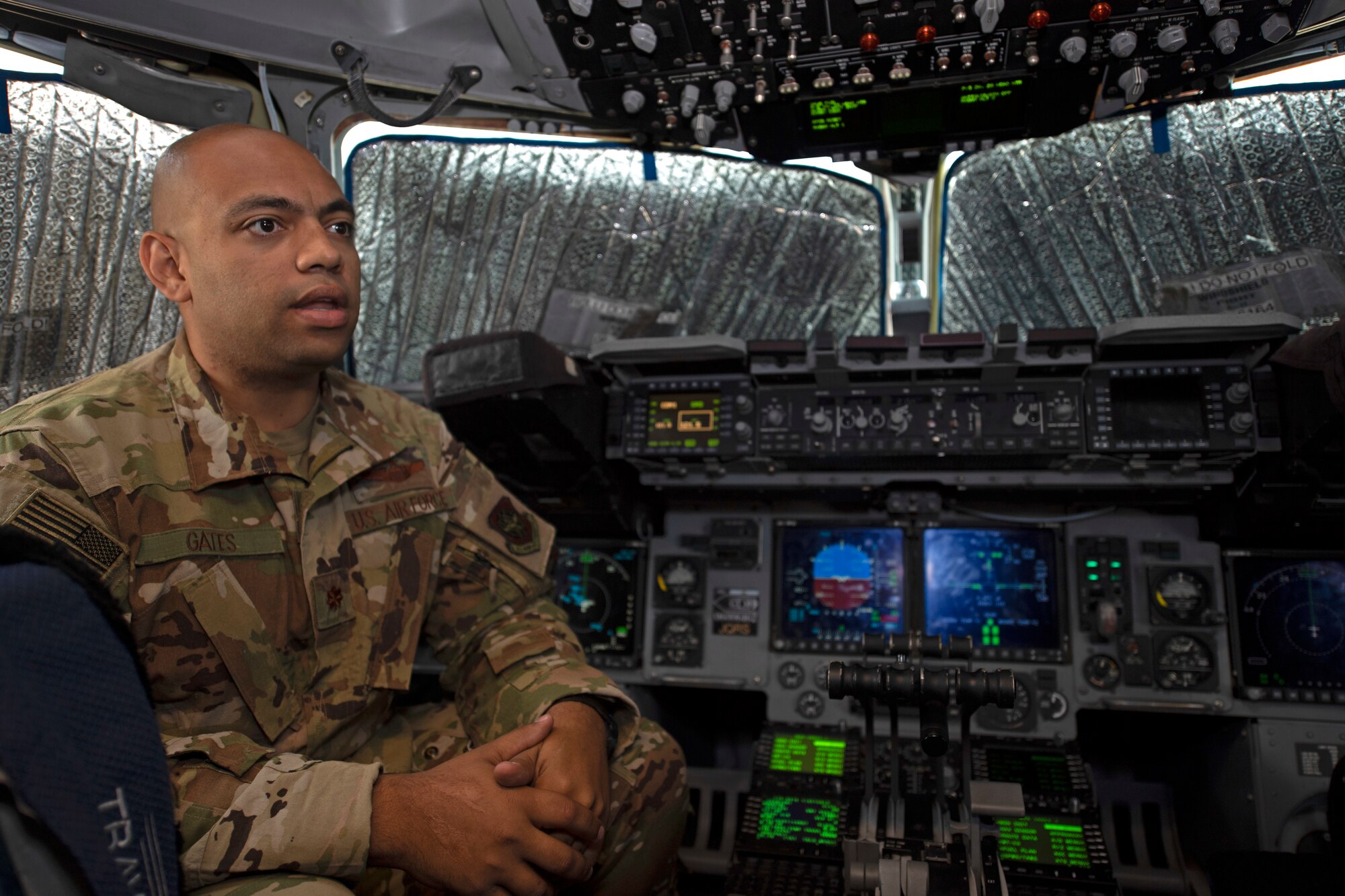 U.S. Air Force Maj. Roger Gates, 21st Airlift Squadron instructor pilot and assistant directive officer, describes a United States Agency for International Development mission Aug. 27, 2020, in a C-17 Globemaster III at Travis Air Force Base, California. Gates has served in the U.S. Air Force for 10 years and is a native of Georgia. (U.S. Air Force photo by Senior Airman Jonathon Carnell)