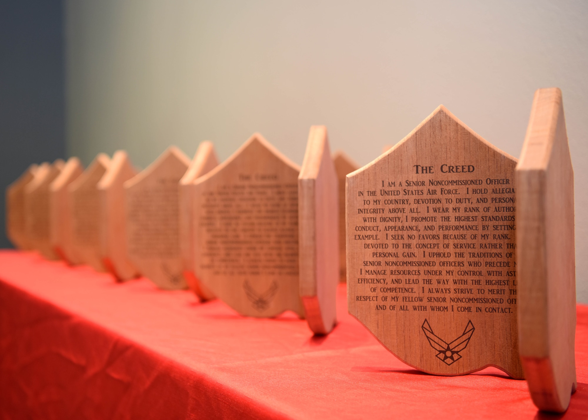 Plaques sit on a table displaying the senior noncommissioned officer creed during the SNCO Induction Ceremony at the event center on Goodfellow Air Force Base, Texas, Aug. 27, 2020. The SNCO inductees vowed to uphold the creed during the induction ceremony. (U.S. Air Force photo by Airman 1st Class Ethan Sherwood)
