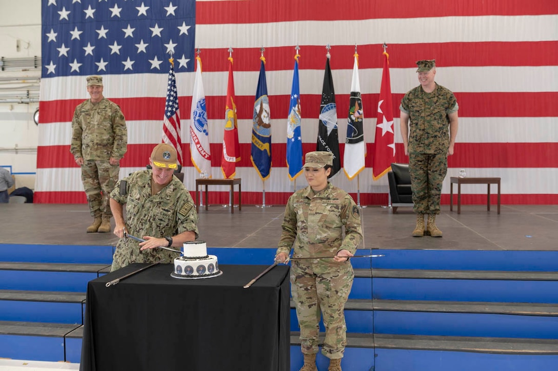 U.S. Navy Rear Adm. Michael Bernacchi, rightt, and U.S. Air Force Staff Sgt. Kiara Kashner, right, representing U.S. Space Command’s longest-serving and junior-serving members, respectively, cut a cake in honor of the combatant command’s first birthday Aug. 28, 2020, at Peterson Air Force Base, Colorado. Kashner serves as executive assistant to the commandant and Bernacchi is Strategy, Plans and Policy director. USSPACECOM was officially established Aug. 29, 2019, during a ceremony in the White House Rose Garden with President Donald Trump; Dr. Mark T. Esper. Secretary of Defense; and Gen. John W. “Jay” Raymond, former USSPACECOM commander and current U.S. Space Force Chief of Space Operations; and Chief Master Sgt. Roger Towberman, former USSPACECOM command senior enlisted leader and current USSF CSEL.