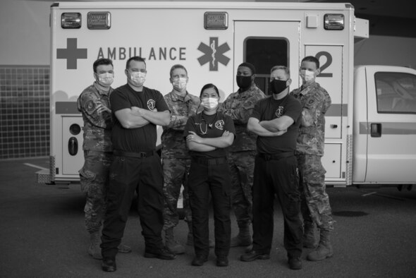 U.S. Airmen assigned to the 60th Medical Operation Squadron stand in front of an ambulance Aug. 26, 2020, at Travis Air Force Base, California. These members of the 60th MDS were part of a team that evacuated 20 patients from David Grant USAF Medical Center Aug. 19, after the 60th Air Mobility Wing commander issued an evacuation order for Travis AFB in response to a wildfire nearing the installation. (U.S. Air Force photo by Senior Airman Cameron Otte)