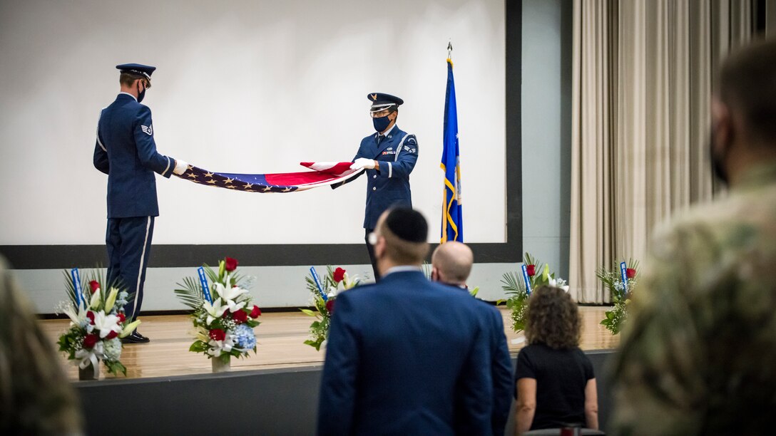 The Blue Eagles Honor Guard fold a U.S. flag in during a memorial ceremony at Edwards Air Force Base, California. The memorial service was in honor of the 13 Team Edwards members who have passed away this year. (Air Force photo by Giancarlo Casem)