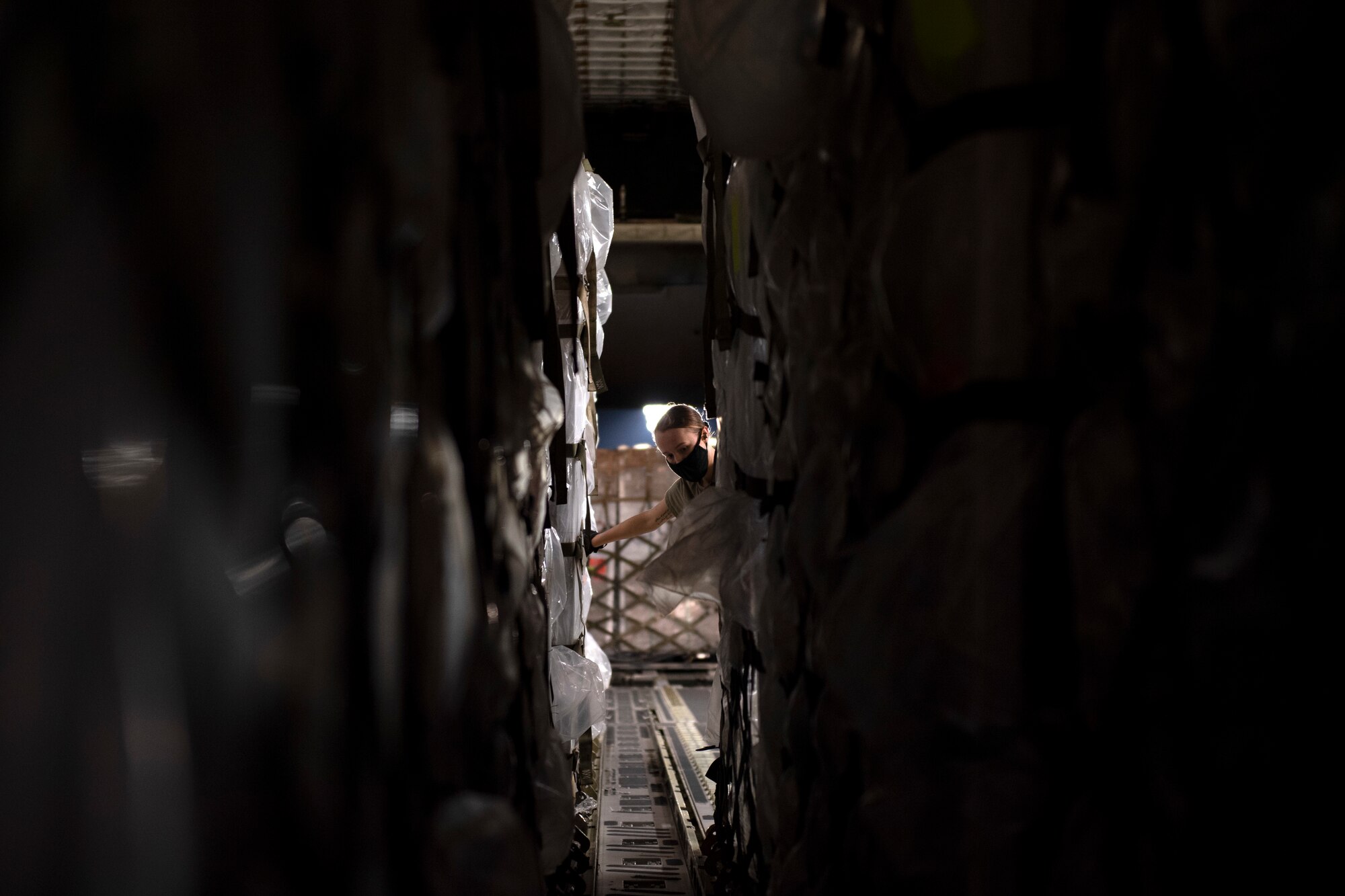 photos of aerial port airmen loading USAID of ventilators into a c-17 globemaster III.