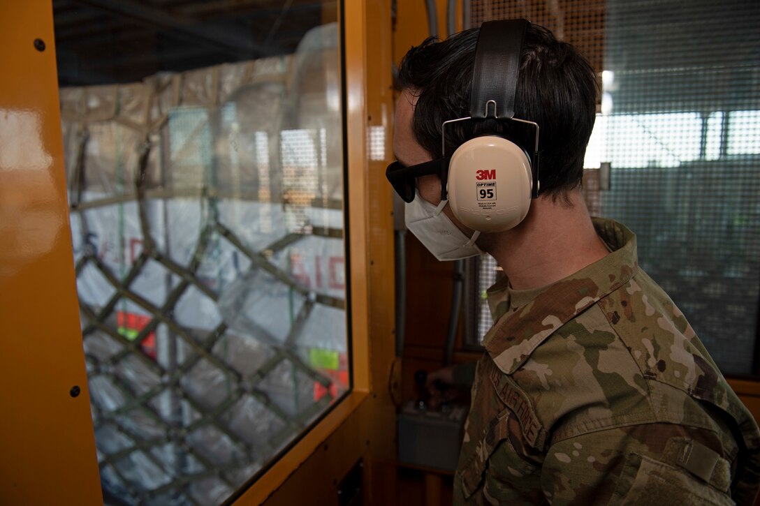 photos of aerial port airmen loading USAID of ventilators into a c-17 globemaster III.