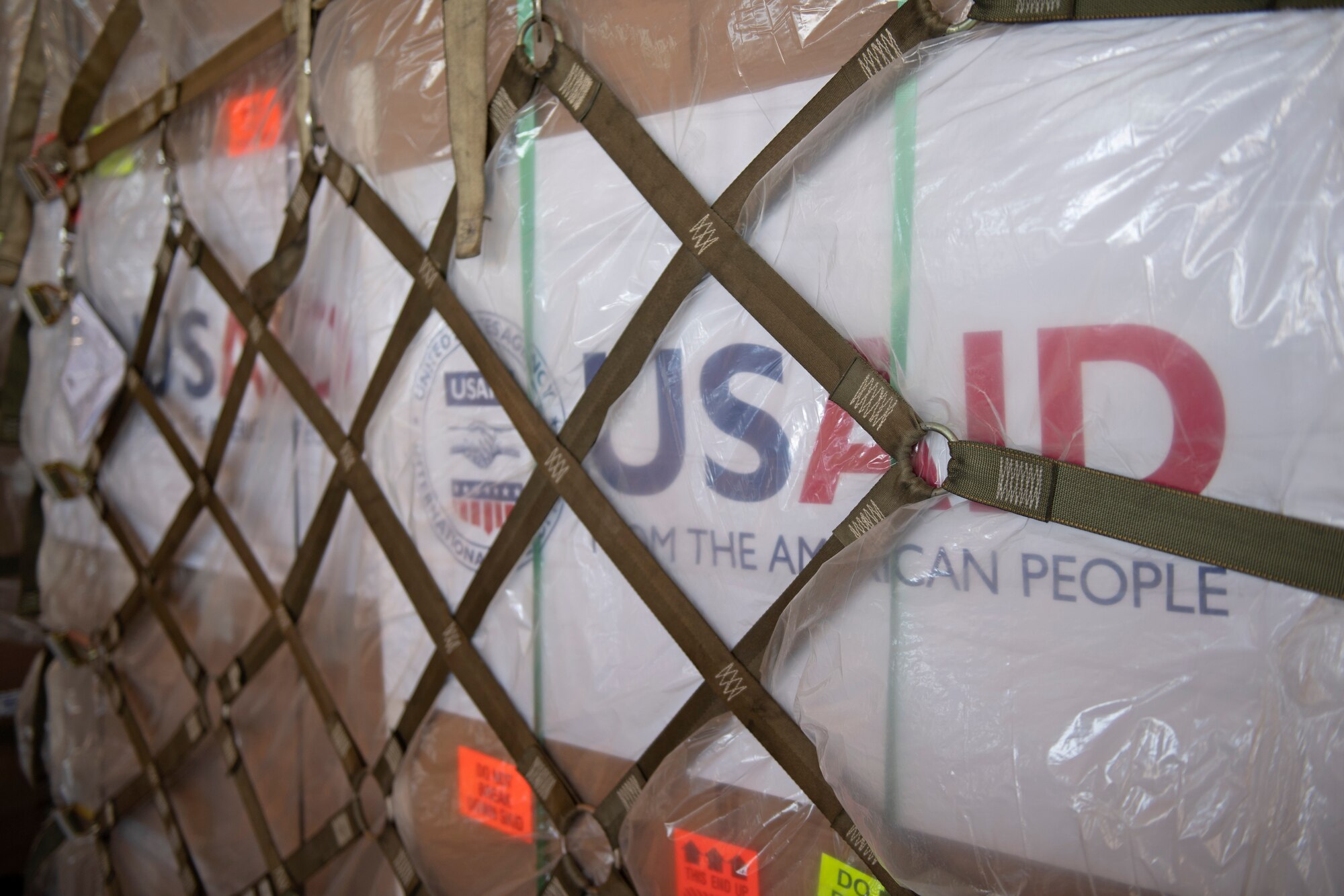 photos of aerial port airmen loading USAID of ventilators into a c-17 globemaster III.