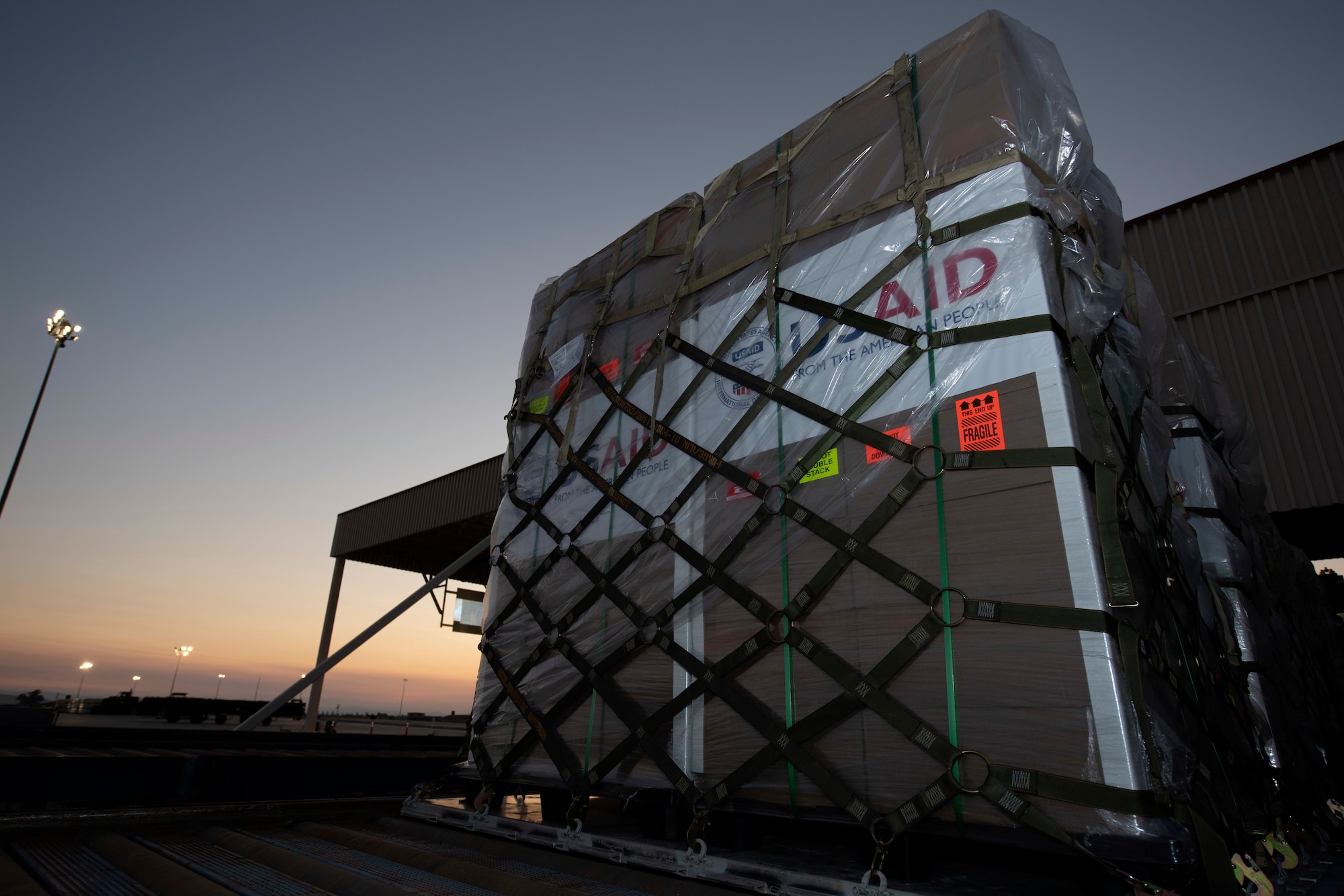 photos of aerial port airmen loading USAID of ventilators into a c-17 globemaster III.