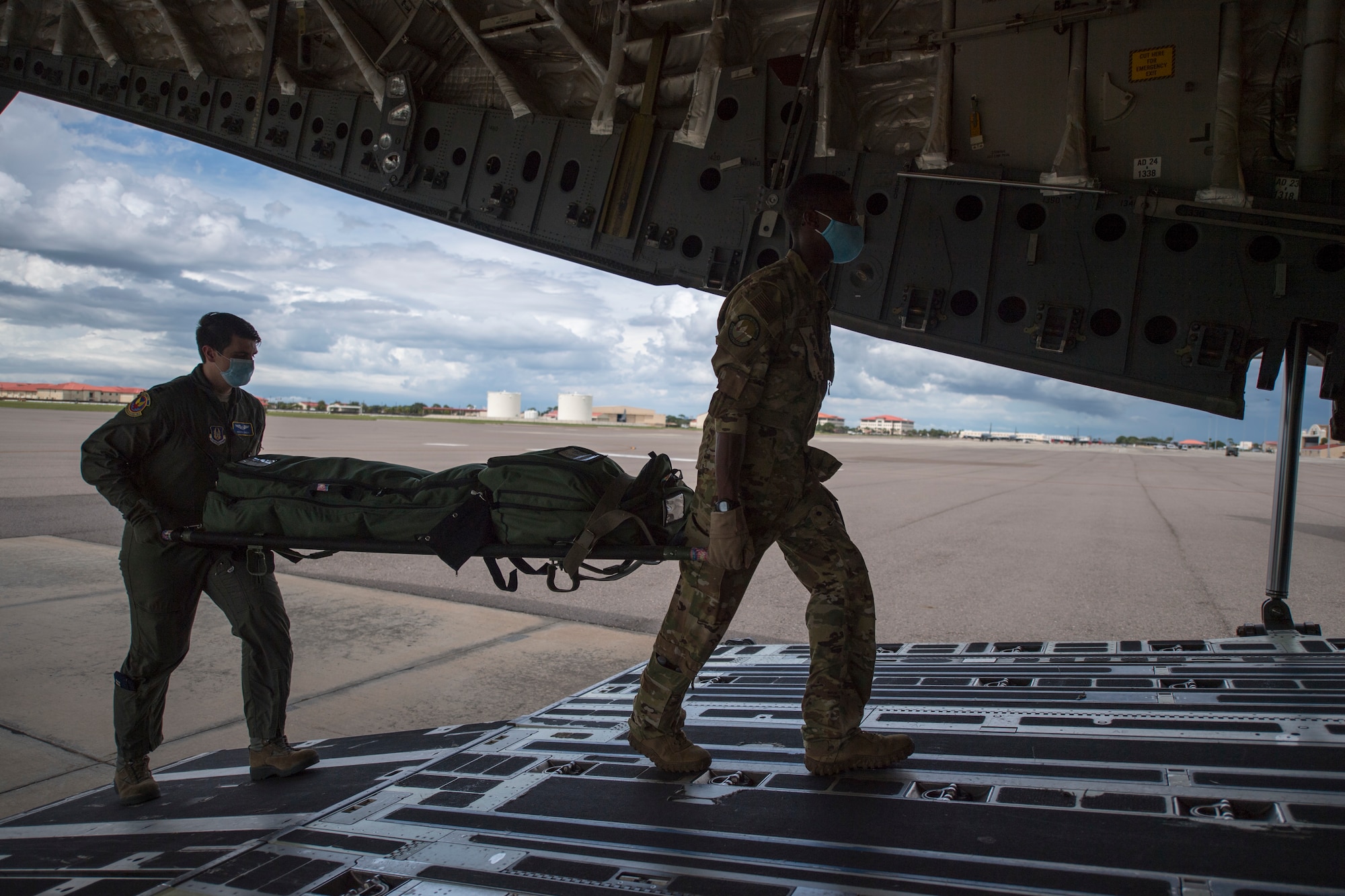 Members of the 908th Aeromedical Evacuation Squadron, Maxwell Air Force Base, Alabama, and the 45th AES, carry a litter of medical supplies onboard a C-17 Globemaster III aircraft assigned to the 512th Airlift Wing, Dover AFB, Delaware, at MacDill AFB, Florida, Aug. 21, 2020. The 908th AES teamed up with the 927th Air Refueling Wing’s 45th AES to conduct on-the-ground and aerial medical training to maximize mission readiness. (U.S. Air Force photo by Staff Sgt. Adam R. Shanks)