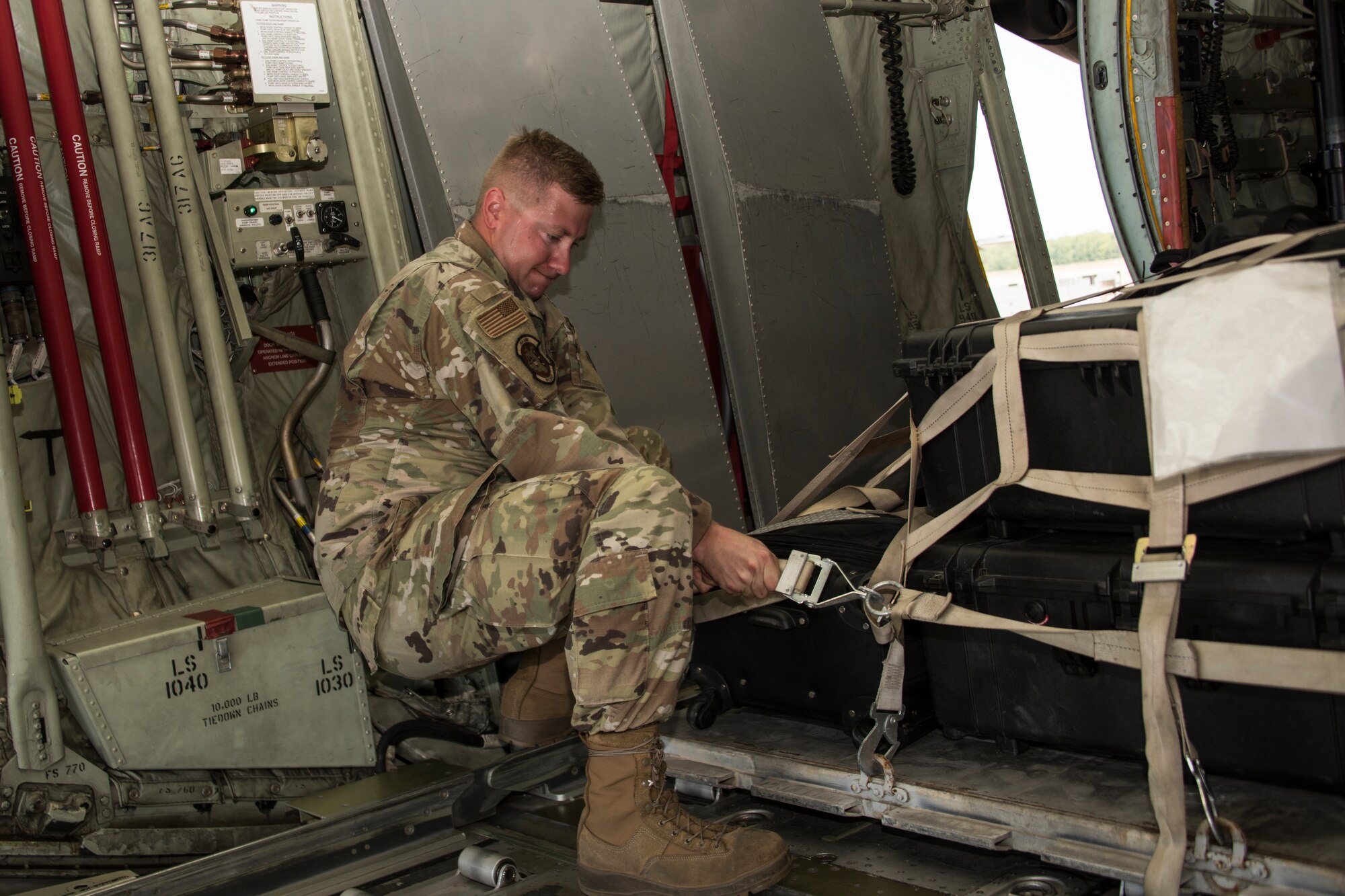 A photo of Airmen strapping down cargo