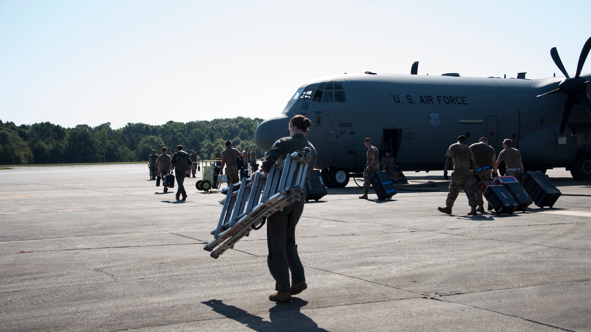 A photo of Airmen moving gear