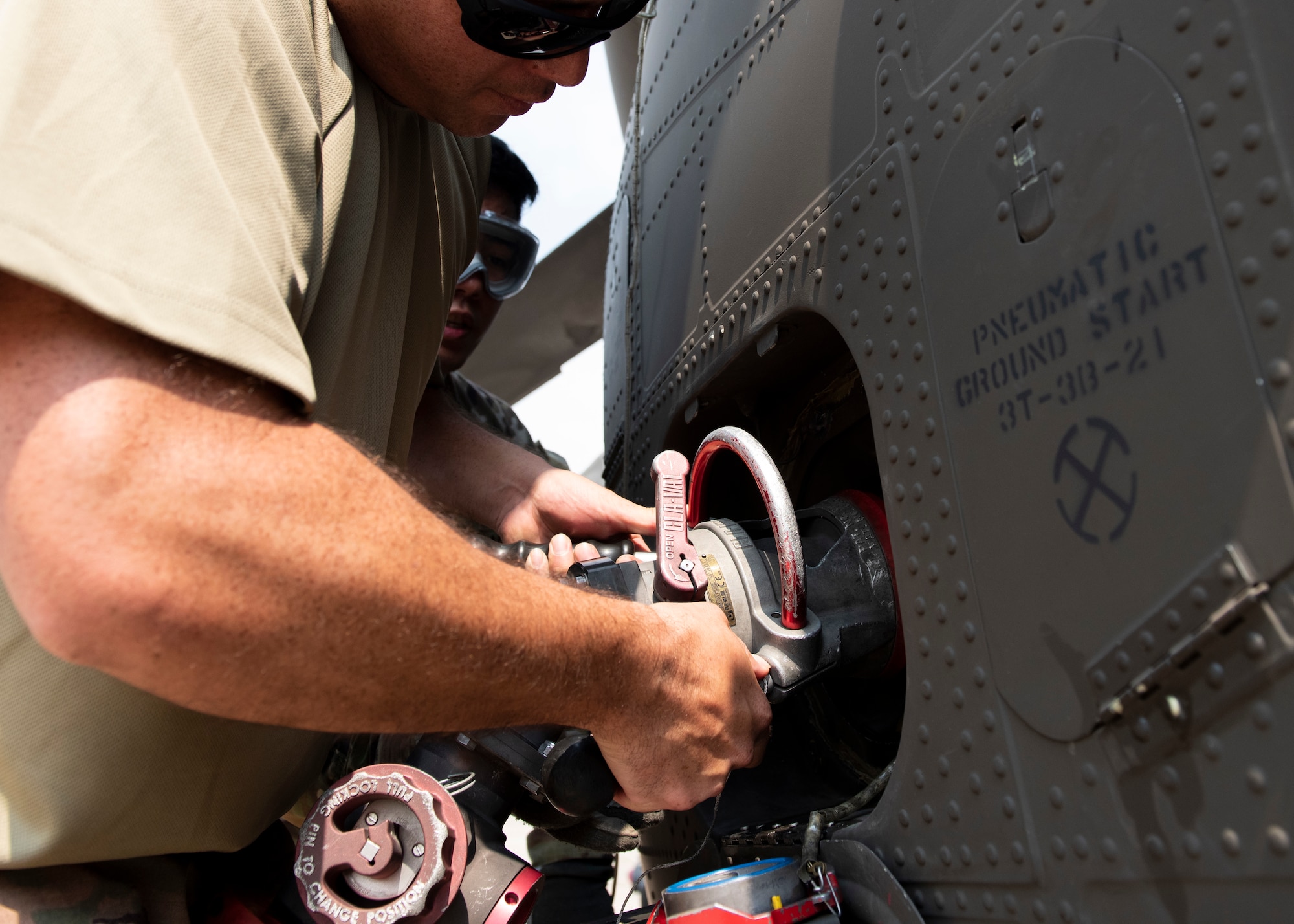 Airman using a fuel hose
