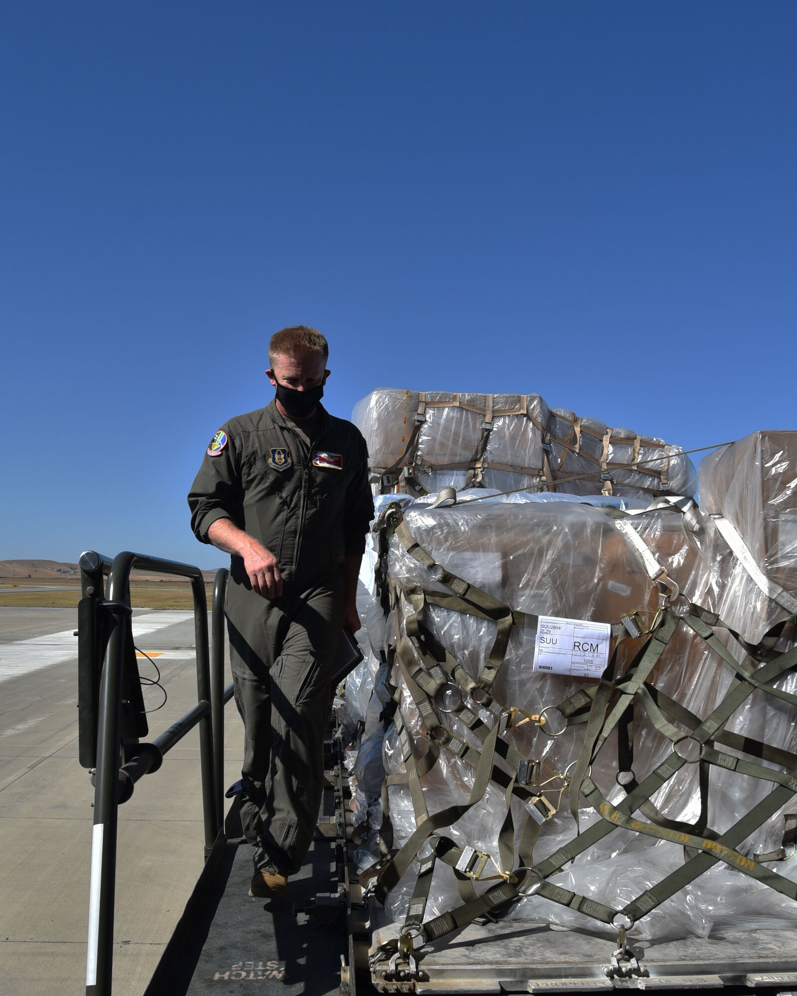 Senior Master Sgt. Bryan Fehrenbach (left) and Senior Airman Madison Doherty (right), 924th Air Refueling Squadron boom operators and load masters, haul a cargo pallet onto a KC-46A Pegasus assigned to McConnell Air Force Base, Kansas, Aug. 15, 2020, at Travis Air Force Base, California. This was the first Reserve-lead cargo load utilizing the KC-46.