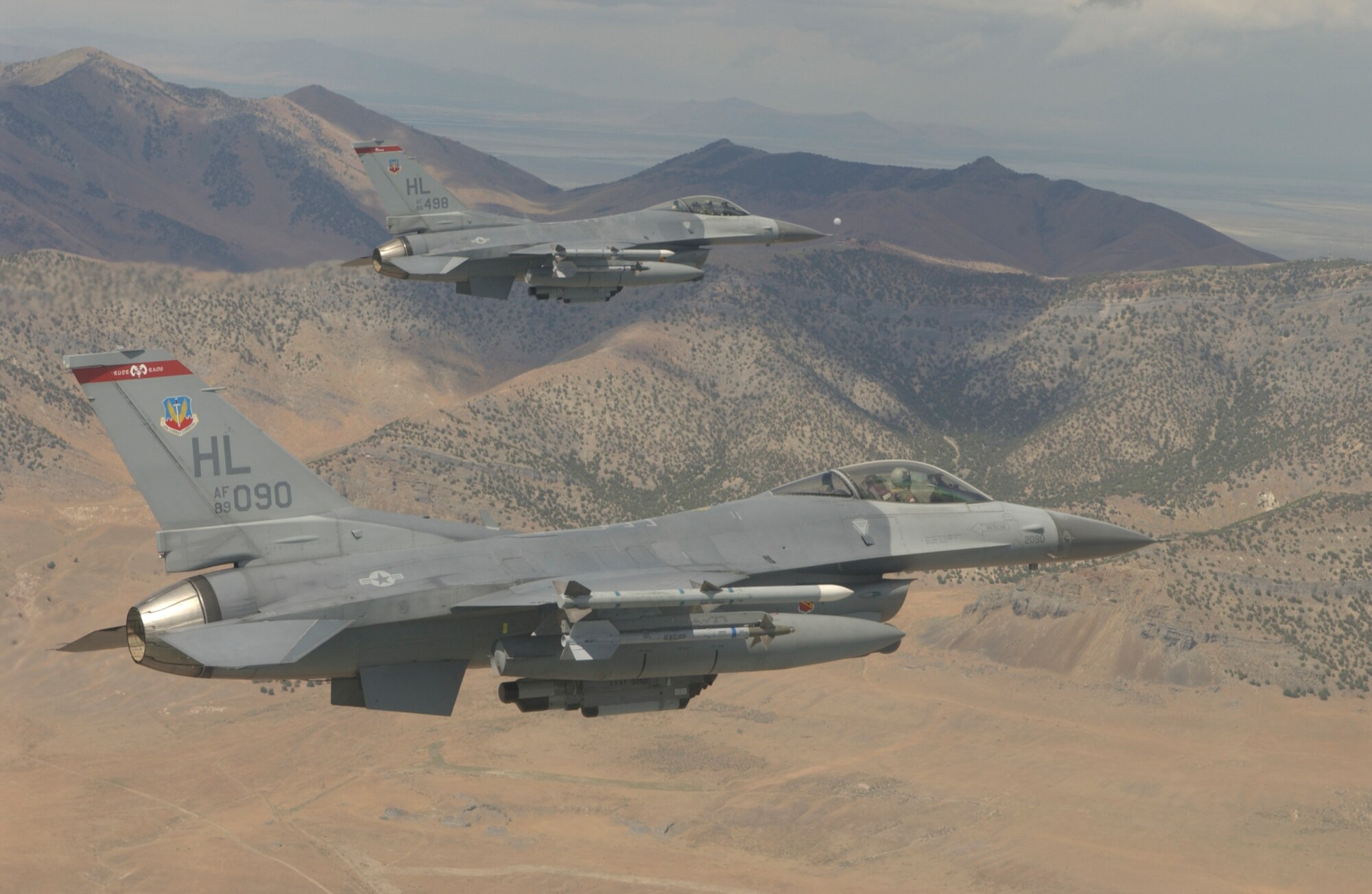 Patrolling the skies outside of Salt Lake City, Utah, a pair of F-16 Vipers, flown by 1Lt Brian "Deuce" Wilder (bottom) and Lt Col Michael "Skeeter" Rothstein (top) have played a vital role in the nation's Homeland Defense mission by providing nonstop aerial deterance over the U.S. capitol in Washington, DC, as well as securing the skies around Salt Lake city during the 2002 Olympic Games. The F-16's are based out of the 34th Fighter Squadron at Hill AFB, Utah.