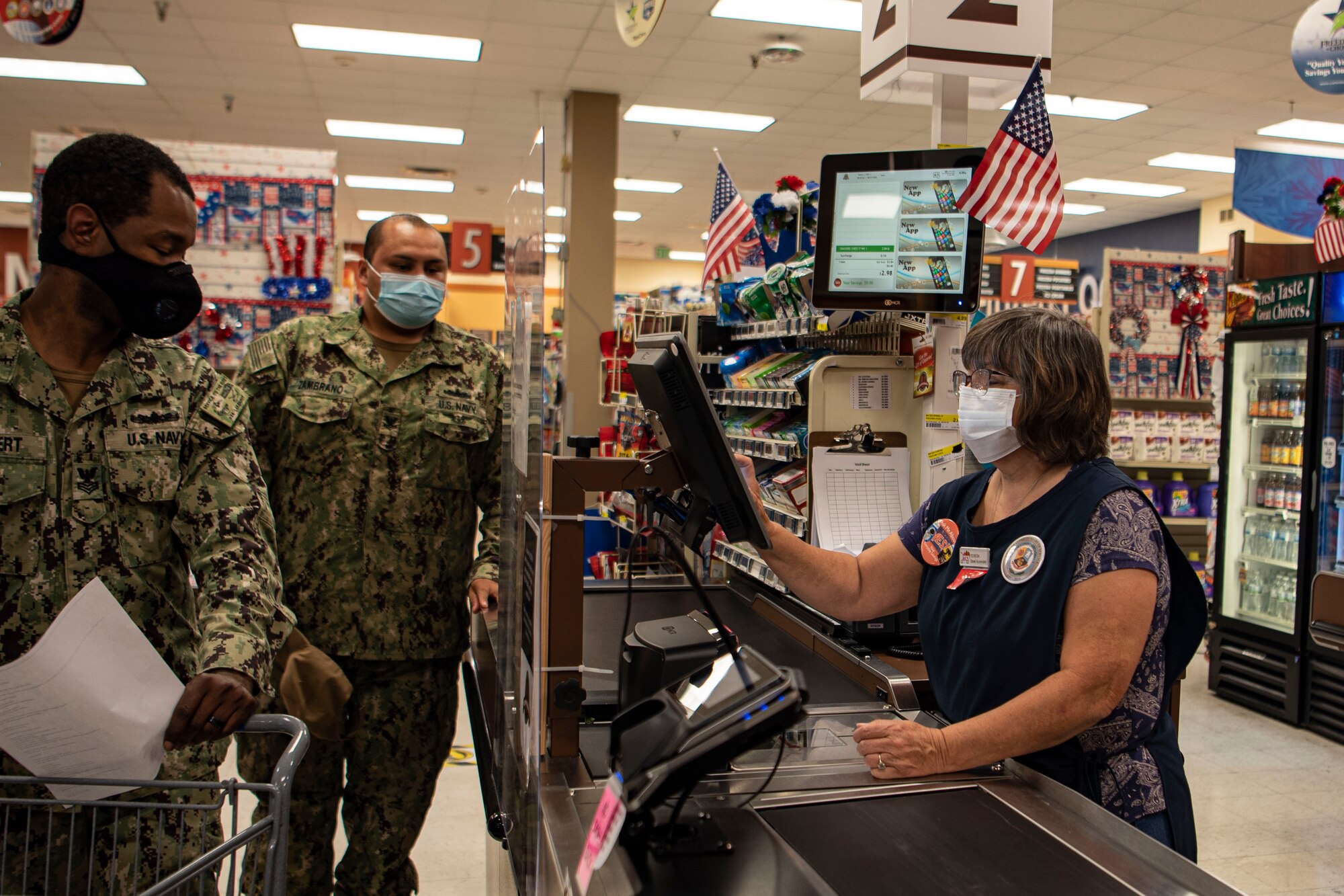 Photo of sailors checking out groceries.