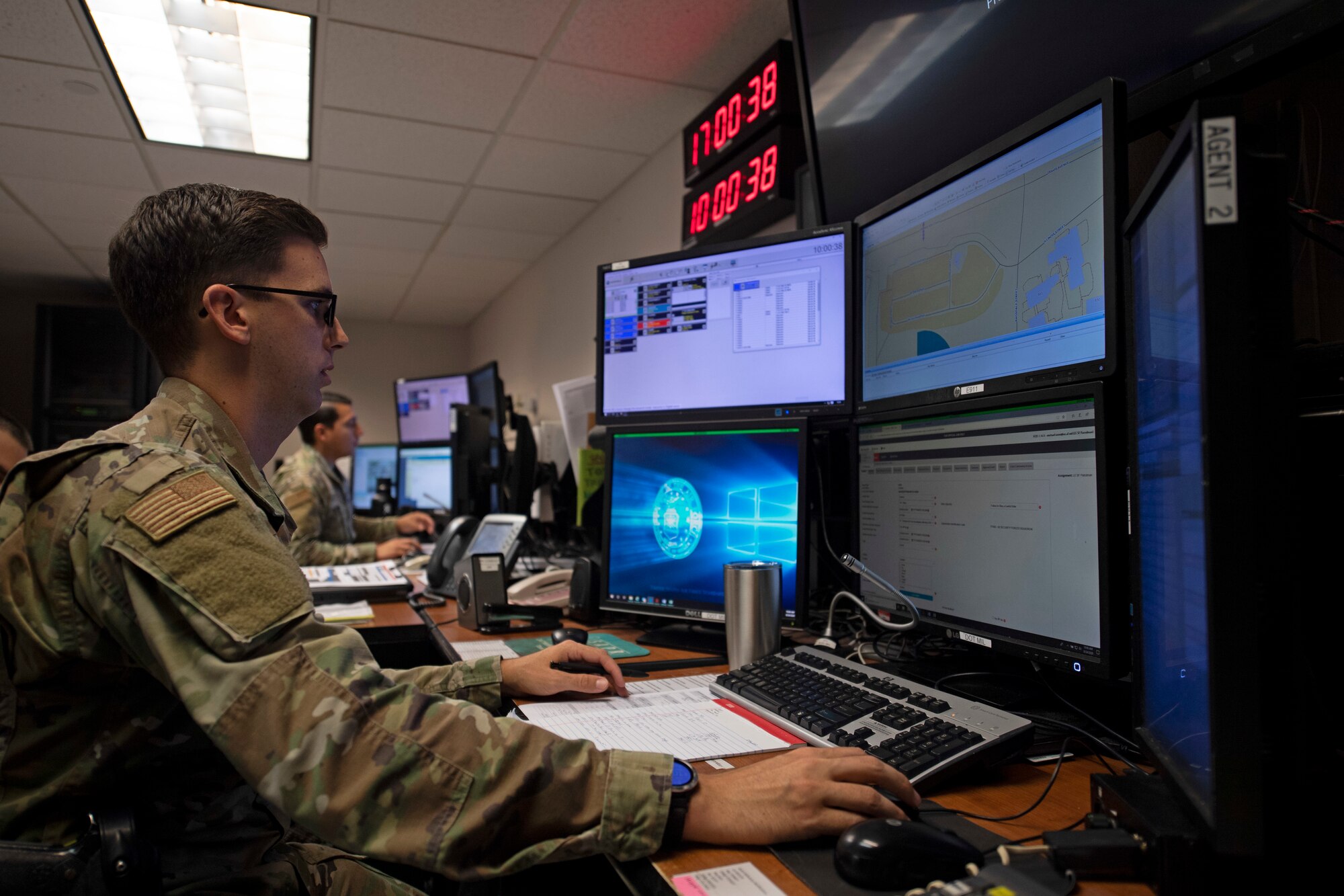 U.S. Air Force Staff Sgt. Michael Itami, 60th Security Forces Squadron emergency communications center controller, describes the process of dispatching patrols Aug. 24, 2020, at Travis Air Force Base, California. The SFS was notified Aug. 19 to evacuate more than 8,000 base personnel due to the wildfires that have burned more than 1.5 million acres in the surrounding area. (U.S. Air Force photo by Senior Airman Jonathon Carnell)