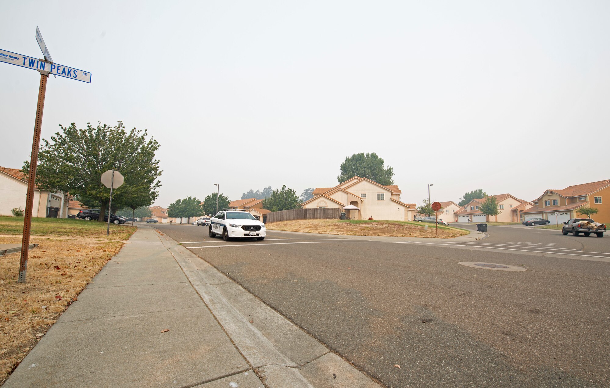 U.S. Air Force Senior Airman Dominique King, 60th Security Forces Squadron patrolman, patrols a neighborhood Aug. 24, 2020, at Travis Air Force Base, California. The SFS was notified Aug. 19 to evacuate more than 8,000 base personnel due to the wildfires that have burned more than 1.5 million acres in the surrounding area. (U.S. Air Force photo by Senior Airman Jonathon Carnell)