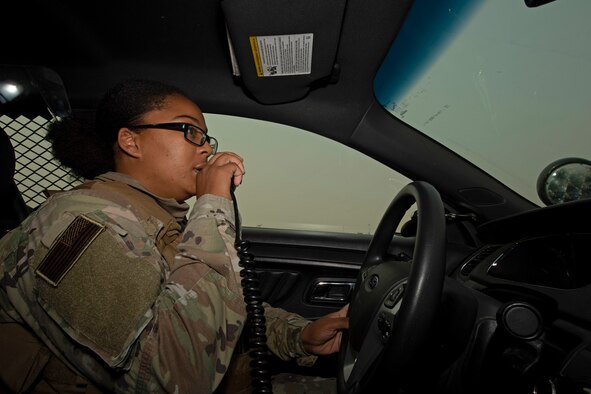 U.S. Air Force Senior Airman Dominique King, 60th Security Forces Squadron patrolman, talks on a radio Aug. 24, 2020, at Travis Air Force Base, California. The SFS was notified Aug. 19 to evacuate more than 8,000 base personnel due to the wildfires that have burned more than 1.5 million acres in the surrounding area. (U.S. Air Force photo by Senior Airman Jonathon Carnell)