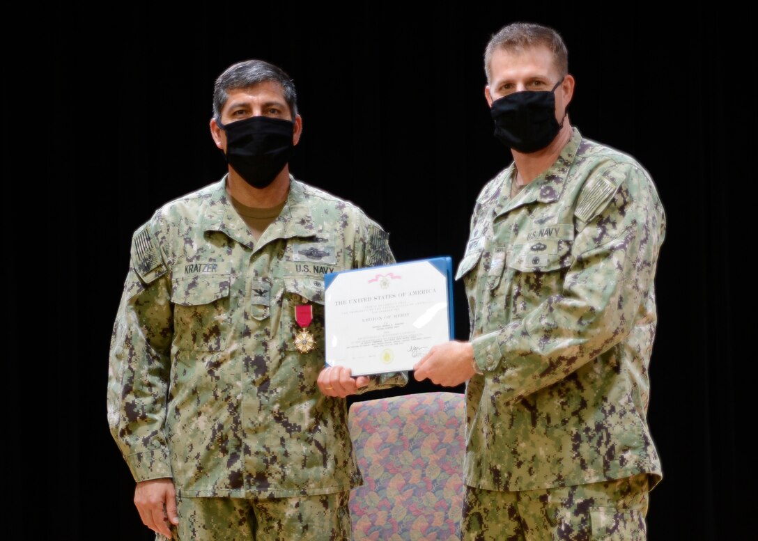 200826-N-HU235-1033 MANAMA, Bahrain (August 26, 2020) Capt. Greg Smith, commanding officer of Naval Support Activity (NSA) Bahrain, right, presents the Legion of Merit to Capt. Gadala Kratzer during a change of charge ceremony for Task Force Shore Battle Space (TF-SBS) and Navy Region Europe, Africa Central (EURAFCENT) Detachment Bahrain on board NSA Bahrain, Aug 26. Capt. Keith Wooley relieved Kratzer during the ceremony. TF-SBS and Navy Region EURAFCENT Detachment Bahrain coordinate all facility and security support for shore installations in the U.S. 5th Fleet area of operations. (U.S. Navy photo by Mass Communication Specialist 1st Class Cody R. Boyd)