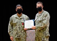 200826-N-HU235-1033 MANAMA, Bahrain (August 26, 2020) Capt. Greg Smith, commanding officer of Naval Support Activity (NSA) Bahrain, right, presents the Legion of Merit to Capt. Gadala Kratzer during a change of charge ceremony for Task Force Shore Battle Space (TF-SBS) and Navy Region Europe, Africa Central (EURAFCENT) Detachment Bahrain on board NSA Bahrain, Aug 26. Capt. Keith Wooley relieved Kratzer during the ceremony. TF-SBS and Navy Region EURAFCENT Detachment Bahrain coordinate all facility and security support for shore installations in the U.S. 5th Fleet area of operations. (U.S. Navy photo by Mass Communication Specialist 1st Class Cody R. Boyd)