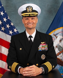 Official portrait of Capt. Kavon Hakimzadeh, the commanding officer of Nimitz-class aircraft carrier USS Harry S. Truman (CVN 75).