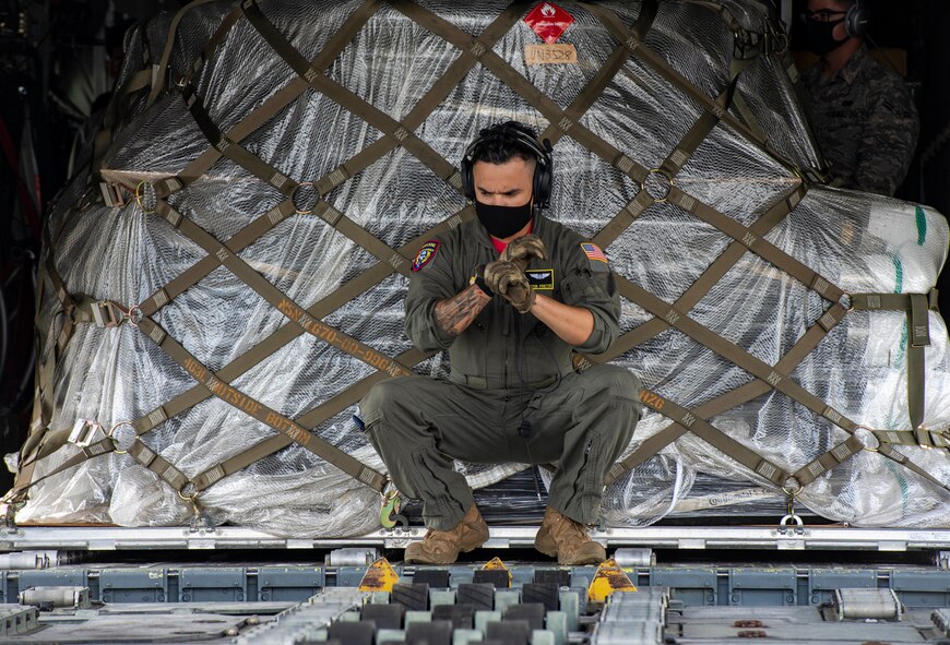 Staff Sgt. Hector Frietze, 36th Airlift Squadron loadmaster, directs a K Loader to a C-130J Super Hercules, assigned to the 36th AS, during bilateral cargo exchange training at Yokota Air Base, Japan, Aug. 28, 2020.