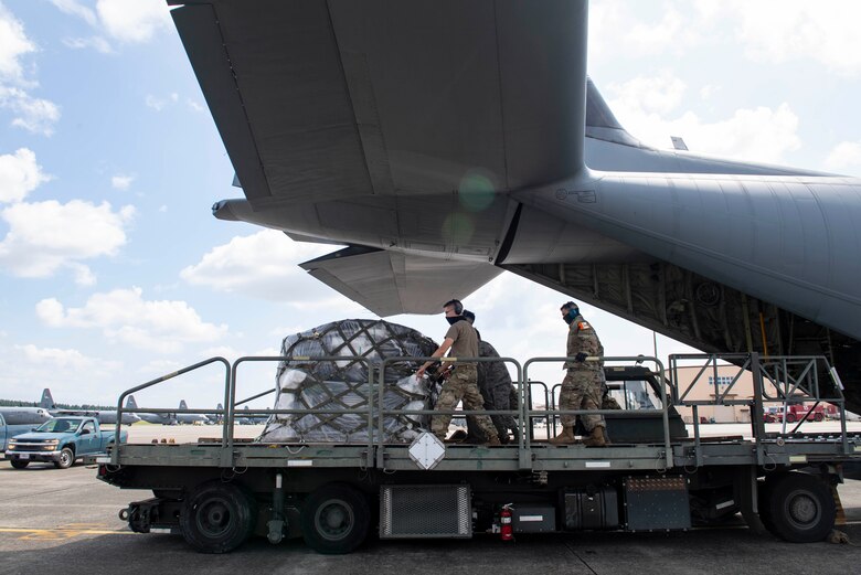 Airmen assigned to the 374th Logistics Readiness Squadron, load cargo onto a K Loader from a C-130J Super Hercules, assigned to the 36th Airlift Squadron, during bilateral exchange training, at Yokota Air Base, Japan, Aug. 28, 2020.