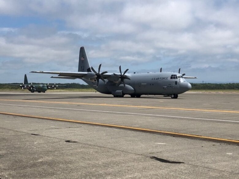 A U.S. Air Force C-130J taxis for take off, followed by a Koku-Jieitai C-130H, during an Aviation Training Relocation event at Chitose Air Base, Japan Aug. 25, 2020.