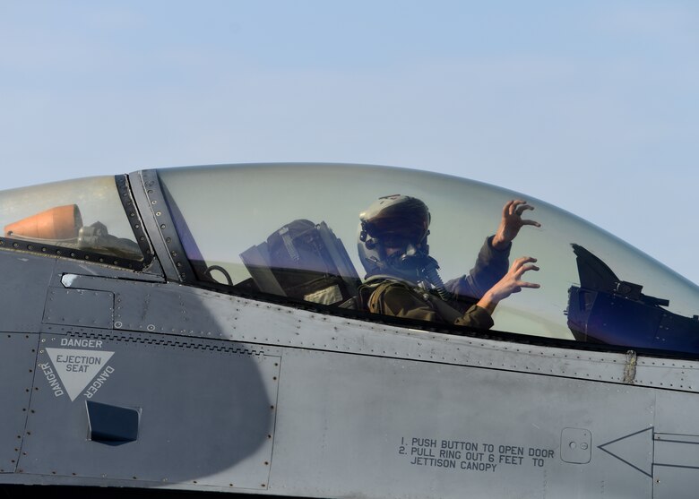 A 13th Fighter Squadron F-16 Fighting Falcon pilot throws up the “panther paw” before takeoff during an Aviation Training Relocation at Chitose Air Base, Japan Aug. 27, 2020.