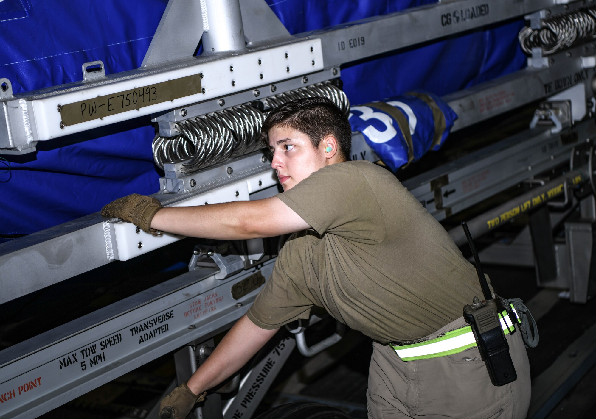 Staff Sgt. Katelyn Ekmalian, 380th Expeditionary Logistics Readiness Squadron passenger service representative, helps to wheel an F-35A Lightning II engine out of a C-17 Globemaster III aircraft, August 26, 2020, at Al Dhafra Air Base, United Arab Emirates.