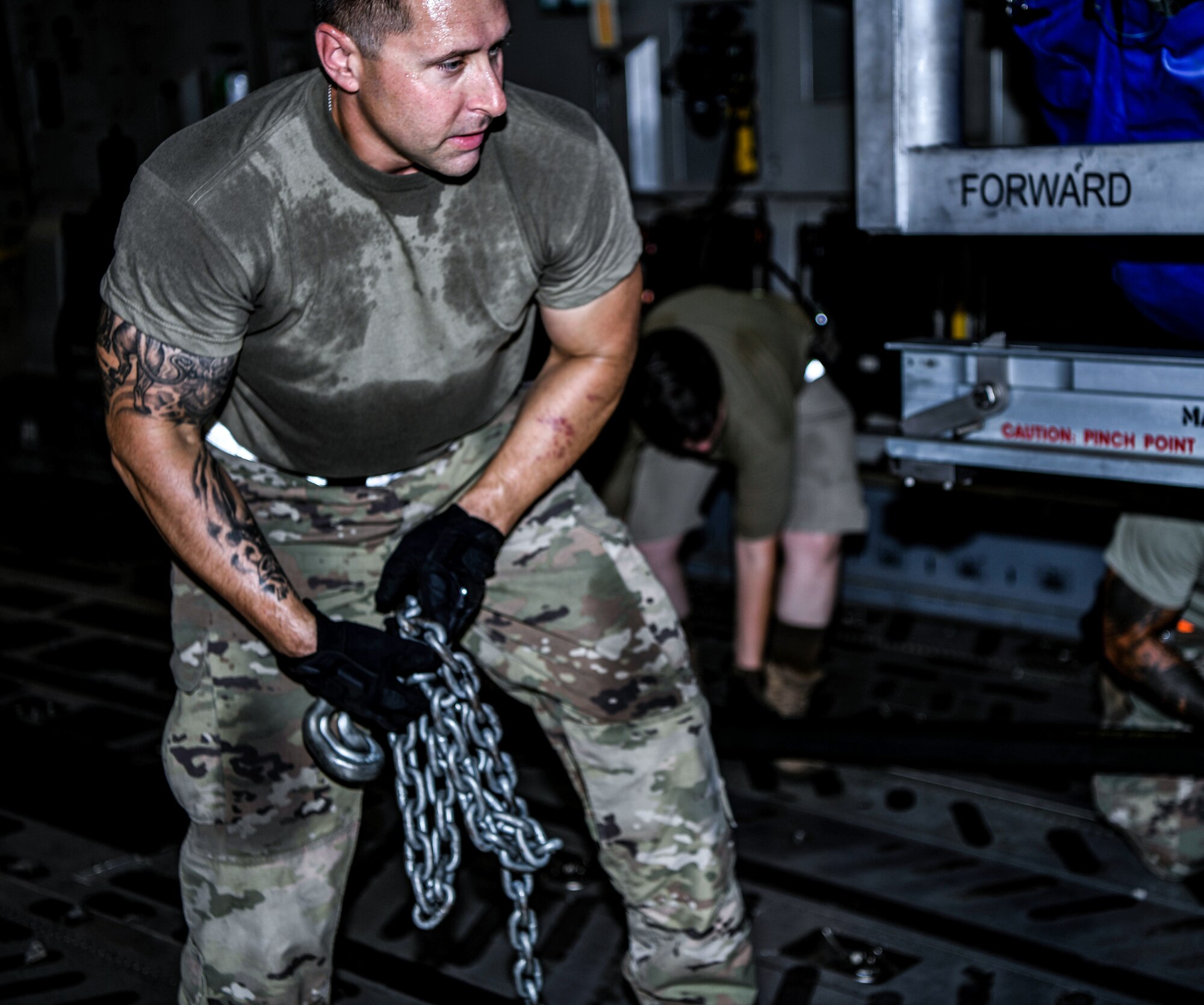 Staff Sgt. Christopher Vechinsky, 380th Expeditionary Logistics Readiness Squadron cargo team chief, picks up a chain after helping to move an F-35A Lighting II engine, August 26, 2020, at Al Dhafra Air Base, United Arab Emirates.