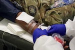 Florida Army National Guard Soldiers from the 50th RSG donate blood at a COVID-19 community-based testing site.