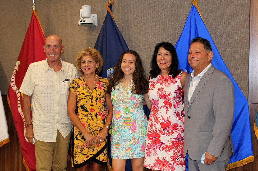 A group of people gather to celebrate a retirement ceremony.