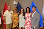 A group of people gather to celebrate a retirement ceremony.