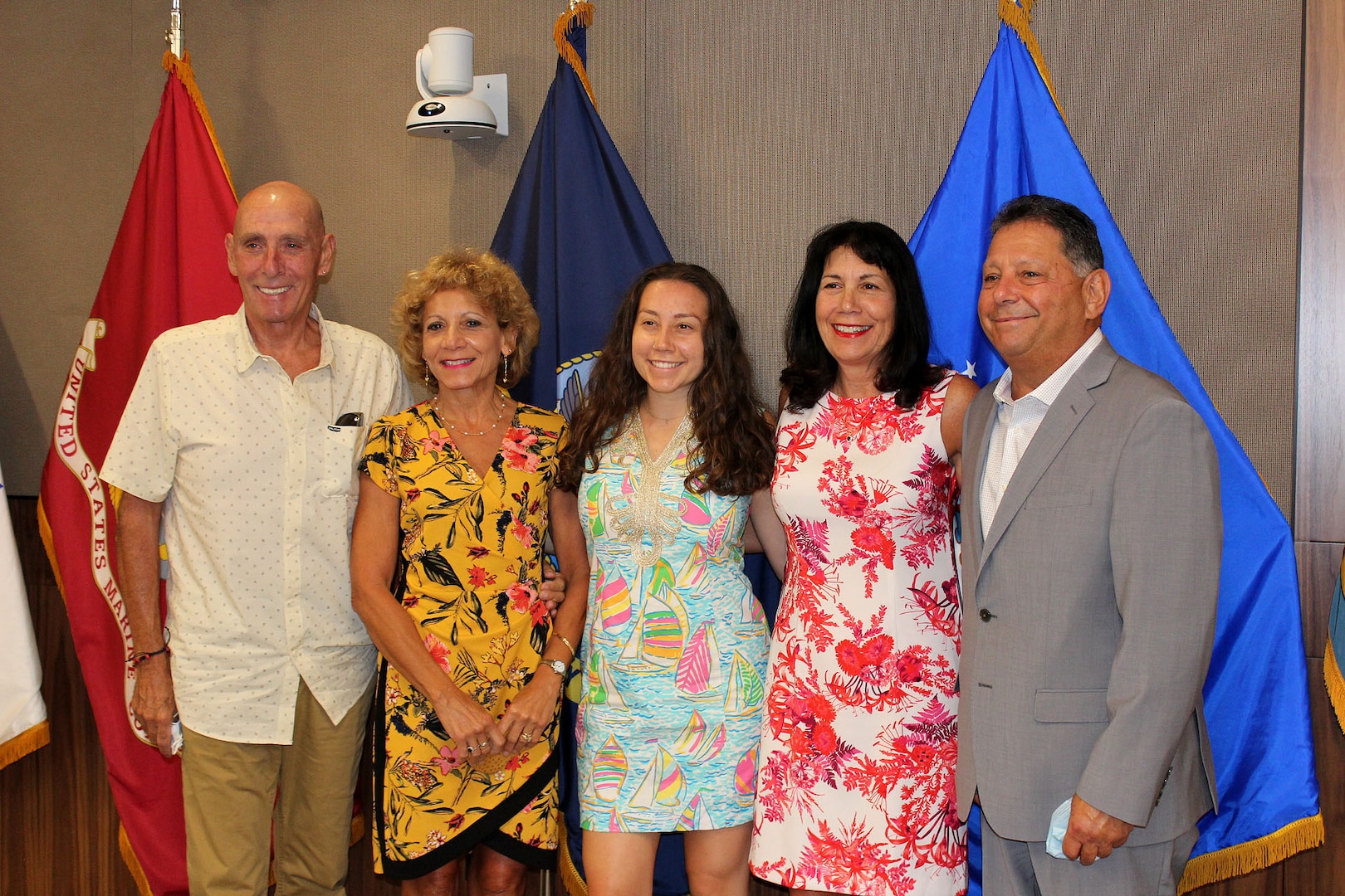 A group of people gather to celebrate a retirement ceremony.