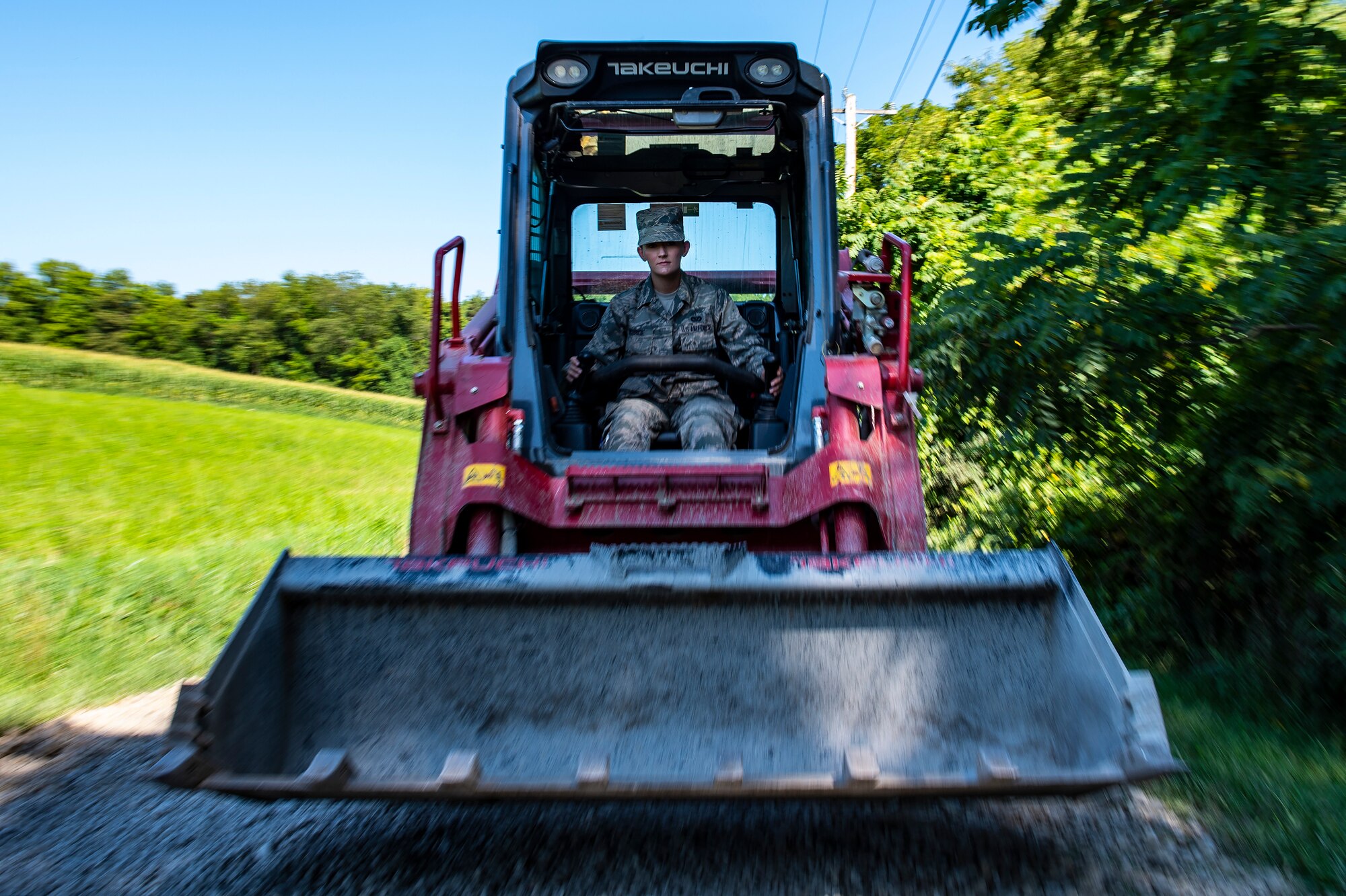 Senior Airman Mara McBride, 911th Civil Engineering Squadron engineering specialist, operates an excavator while re-grading the entrance to the 911th Airlift Wing firing range in Clinton, Pennsylvania, August 13, 2020.