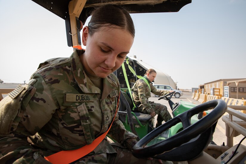 Pfc. Nicole Dubois shifts her Aviation Light Utility Mobile Maintenance Cart (ALUMMC, also known as a “gator”) into gear at the Udairi Landing Zone airfield on Camp Buehring, Kuwait on July 29, 2020. Her sister, Spc. Sarah Dubois, does the same in the ALUMMC next to her as they perform their duties for Alpha Company, 834th Aviation Support Battalion. The sisters are both serving on their first deployment with the Minnesota National Guard in support of Operation Inherent Resolve and Operation Spartan Shield. (U.S. Army photo by Sgt. Sydney Mariette)