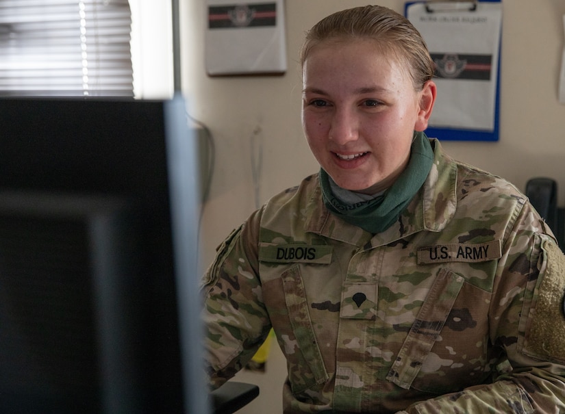 Spc. Sarah Dubois sits at her desk where she reviews work requests to keep the Udairi Landing Zone operational as a member of the airfield management element on Camp Buehring, Kuwait on July 29, 2020.  She is serving on her first deployment with Alpha Company, 834th Aviation Support Battalion in support of Operation Inherent Resolve and Operation Spartan Shield. (U.S. Army photo by Sgt. Sydney Mariette)