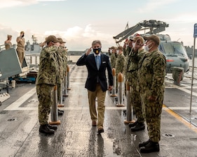 Sideboys render honors as Secretary of the Navy (SECNAV) Kenneth J. Braithwaite proceeds to the quarterdeck of the Freedom-variant littoral combat ship USS Sioux City (LCS 11).