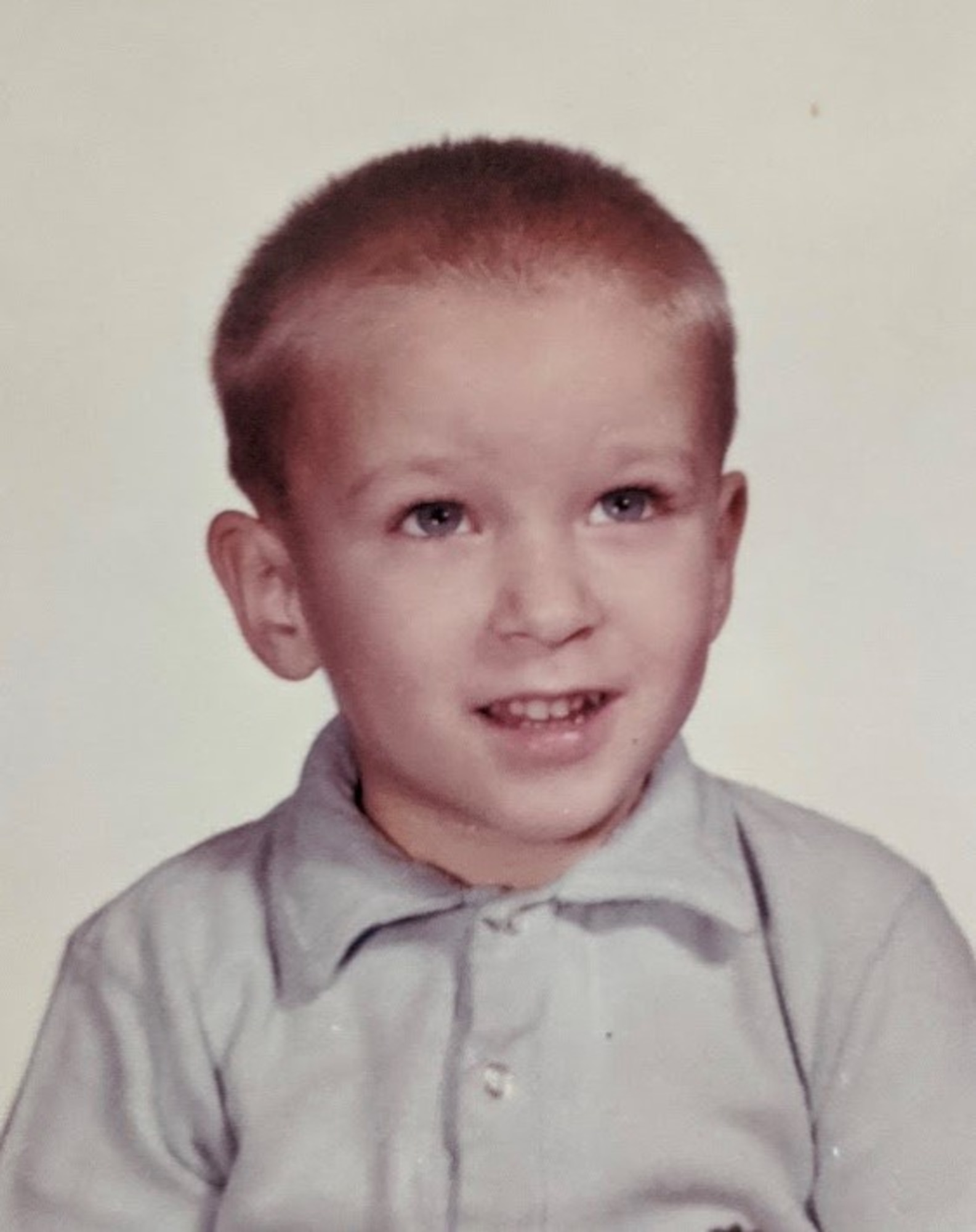 Gary W. Boyd, Air Education and Training Command historian,  poses for a photo at four years old while looking at an airplane being held by the photographer. (Courtesy photo)