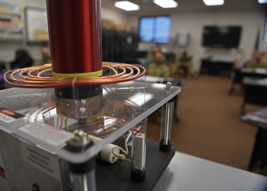 An electrical resonant transformer circuit, more commonly known as a TESLA coil, heats up to display electric sparks before the U.S. Air Force students of the 312th Training Squadron Special Instruments Training course, inside the Louis F. Garland Department of Defense Fire Academy on Goodfellow Air Force Base, Texas, Aug. 19, 2020. The coil produced high-frequency alternating currents, which allowed the SPINSTRA instructors to explain scientific concepts in a visual manner to their students. Additional specialized training may also include: geophysical, nuclear radiation, radiochemical, electro-optical, radio frequency, infrared, radar, and rapidly deployable and fixed airborne collection platforms and nuclear deterrence methods. (U.S. Air Force photo by Senior Airman Abbey Rieves)