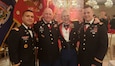 Chief Warrant Officer 4 Thomas Fancher ( second fron the left) stands with Chief Warrant Officer 2 Carlos Perez, Chief Warrant Officer 3 Shawn Stanford and Chief Warrant Officer 3 Ben Lewis ( far right) at the 1-258th Field Artillery Battalion dining out St. Barbara's Ball December 7, 2019.