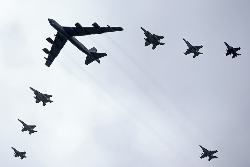 Aircraft fly in formation.