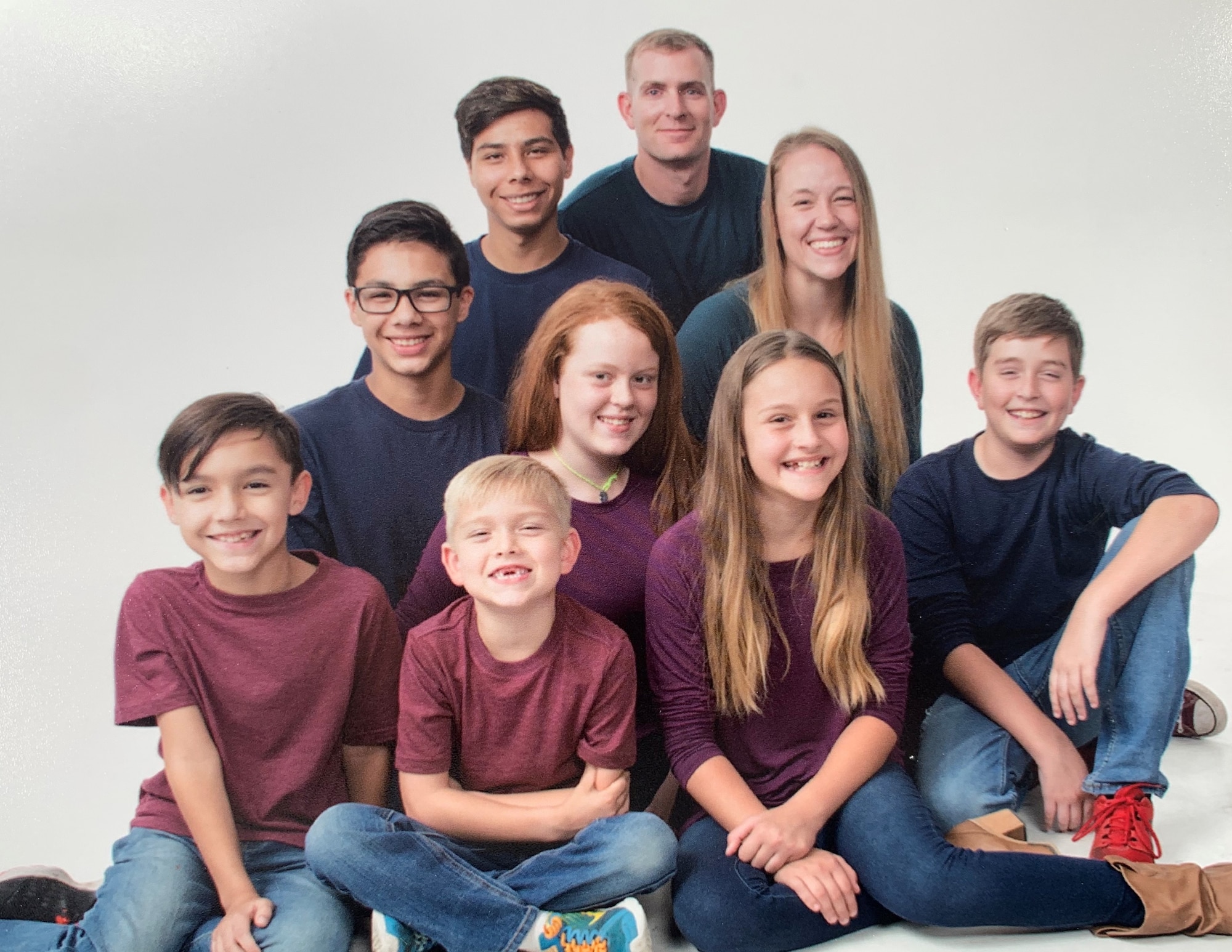 The Neal family takes a family picture shortly before 2nd Lt. Nathan Neal, 315th Training Squadron intelligence instructor, deployed Aug. 2019. The children ranged in age from 8 to 17.  (Courtesy Photo)