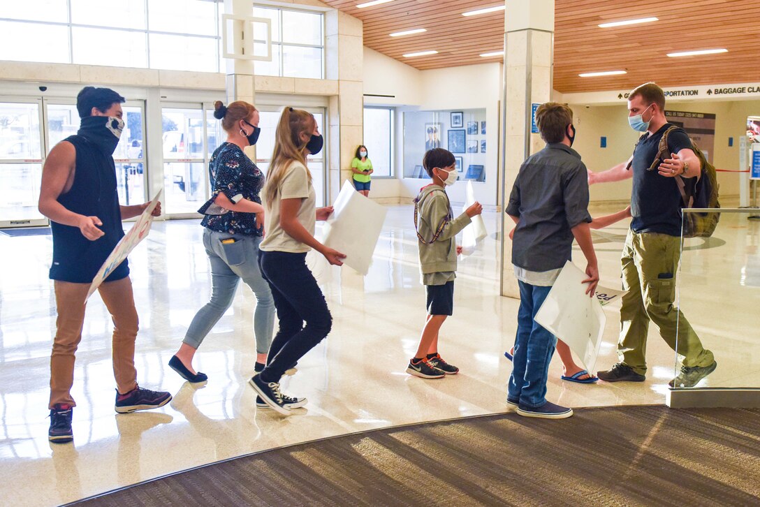 The Neal family rushes in for hugs when 2nd Lt. Nathan Neal, 315th Training Squadron intelligence instructor, arrived home from his deployment Aug. 20, 2020 at Mathis Field, San Angelo, Texas. The Neal family experienced a challenging year with COVID-19 and a year deployment.  (U.S Air Force photo by Aryn Lockhart)