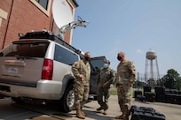 JOINT BASE LANGLEY-EUSTIS, Va. U.S. Army North Command Sergeant Major Phil Barretto views Joint Task Force Civil Support’s communication equipment during a tour of the command’s headquarters with Navy Information Systems Technician 1st Class Albert Givens and Command Chief Master Sgt. James Brown. During his visit, Barretto met with JTF-CS leadership, toured the facilities and held a luncheon with junior enlisted personnel from the command. (U.S. Navy photo by Chief Mass Communication Specialist Barry Riley/RELEASED)