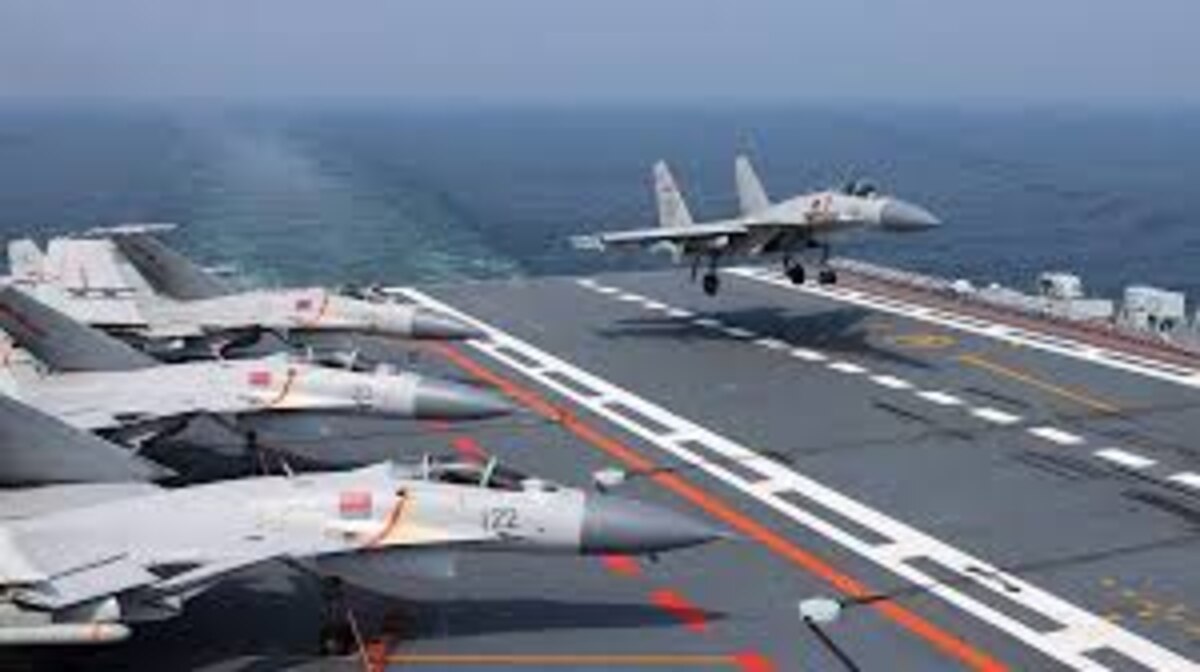 A Chinese fighter lands on an aircraft carrier
