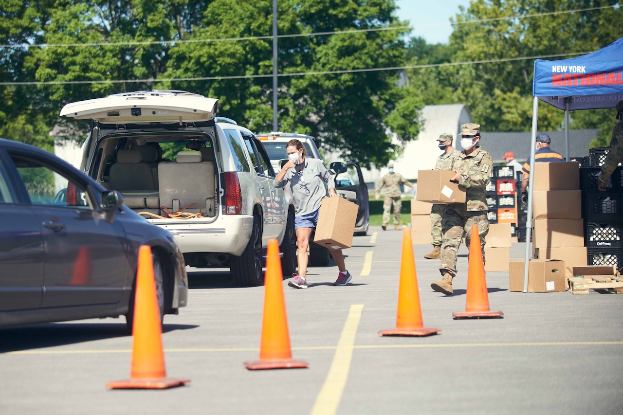 Volunteers hand out food.