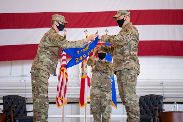 U.S. Air Force Col. Matthew French, commander of the 125th Fighter Wing, (left) salutes U.S. Air Force Lt. Col. Luke Sustman, incoming commander of the 249th Special Operations Squadron, unfurl the new squadron flag during the 249th SOS activation ceremony at Hurlburt Field, Florida, Aug. 28, 2020. The 249th SOS is assigned to the 125th Fighter Wing and is within Air Force Special Operations Command. (U.S. Air Force photo by Airman 1st Class Blake Wiles)