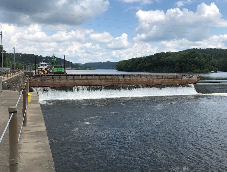 River Salvage's dredging barge set at upstream face of the dam (U.S. Army photo by Joe Premozic)
