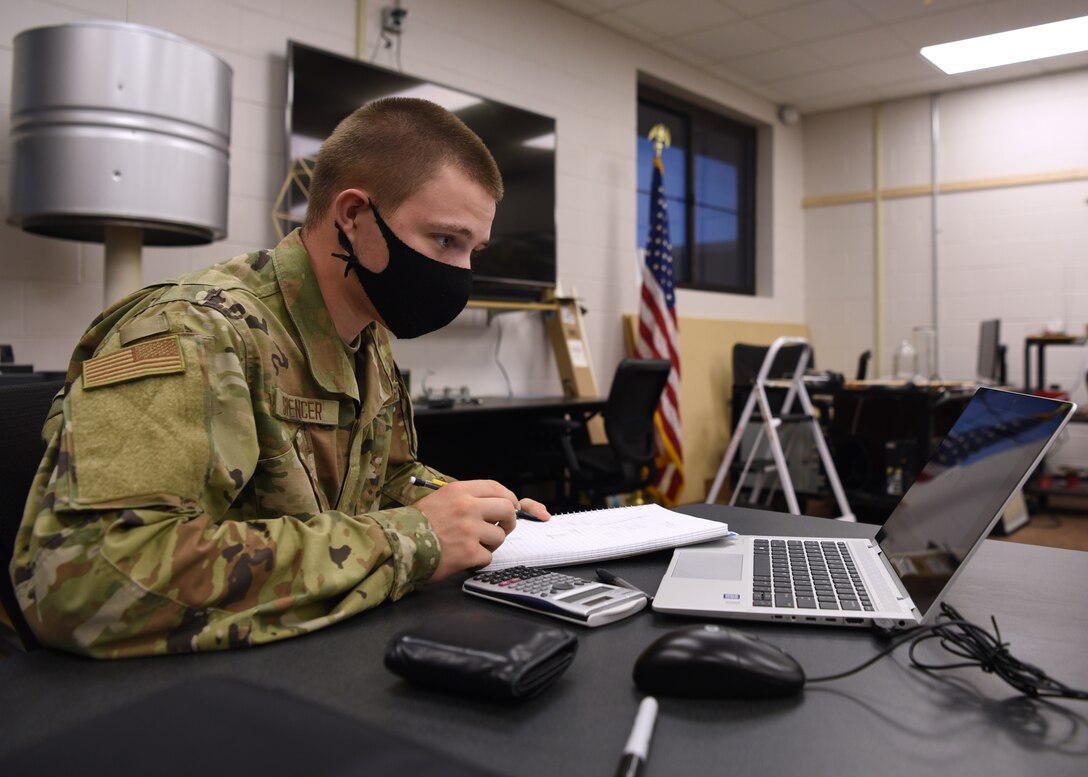 U.S. Air Force Airman Connor Spencer, 312th Training Squadron Special Instruments Training course student, surveys his mathematical materials, inside the Louis F. Garland Department of Defense Fire Academy on Goodfellow Air Force Base, Texas, Aug. 19, 2020. Spencer brushed up on his linear equations since it was his third day in the classroom after graduating from Basic Military Training. (U.S. Air Force photo by Senior Airman Abbey Rieves)