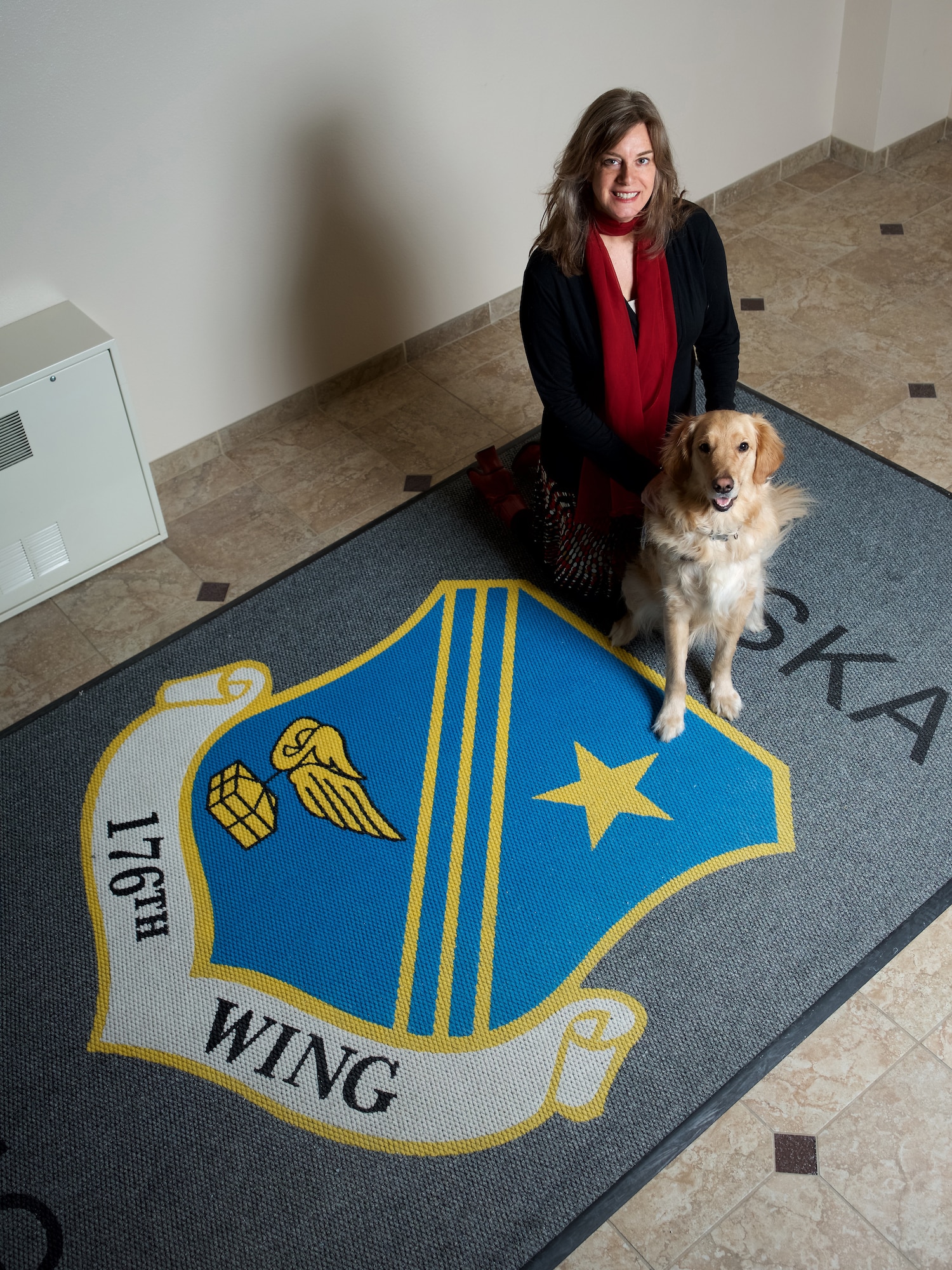 Diann Richardson, 176th Wing director of psychological health, regularly works with therapy dog, Bolt, as part of the licensed clinical social worker’s outreach to the wing. Following several months of socialization and training, the golden retriever became a nationally certified therapy dog.