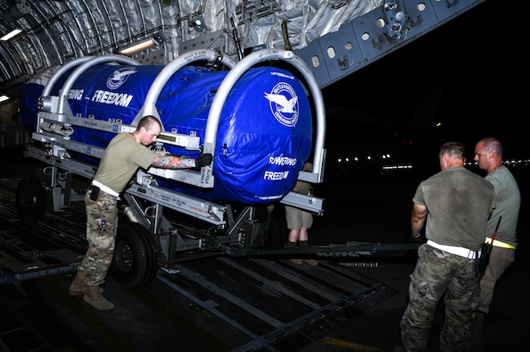 Members of the 380th Expeditionary Logistics Readiness Squadron Air Terminal Operations Center wheel an F-35A Lightning II engine out of a C-17 Globemaster III aircraft, August 26, 2020, at Al Dhafra Air Base, United Arab Emirates.